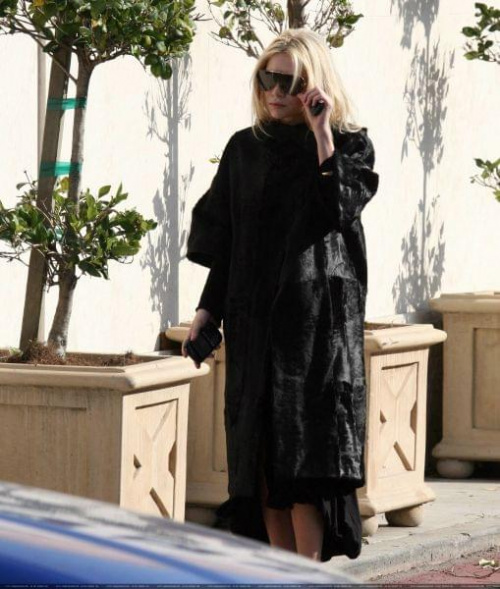 Ashley out and about in a black fur coat