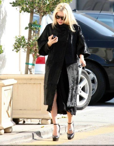 Ashley out and about in a black fur coat