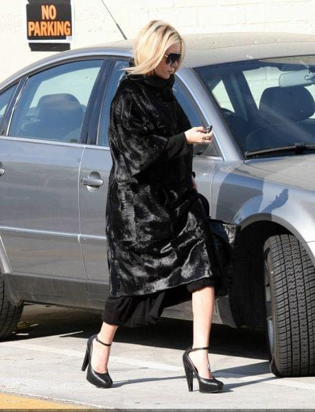 Ashley out and about in a black fur coat